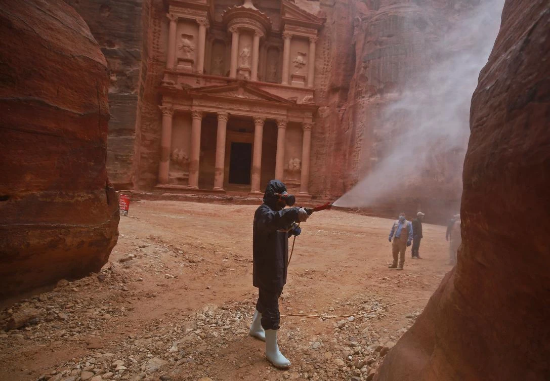 A labourer sprays disinfectant in Jordan's archaeological city of Petra south of the capital Amman on March 17, 2020, to prevent the spread of COVID-19. ( AFP)