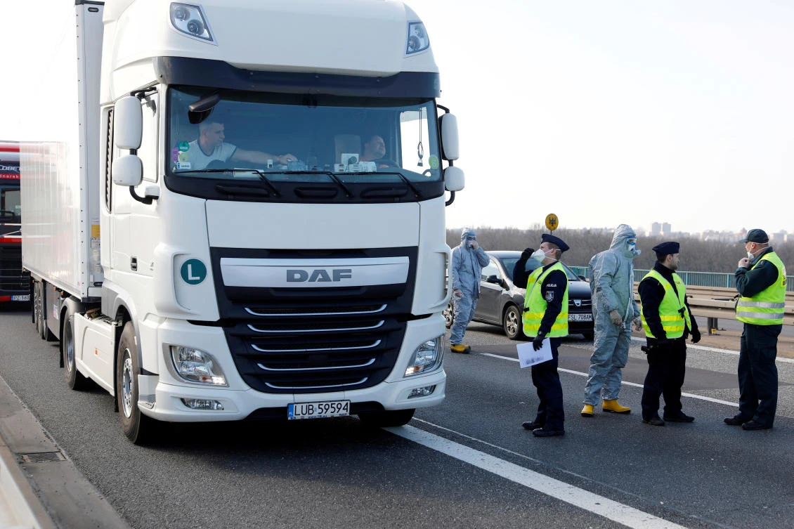 A truck driver waits for his temperature check by Polish officials, during coronavirus (COVID-19) symptoms testing, on the German-Polish border near Frankfurt/Oder, Germany. (Reuters)