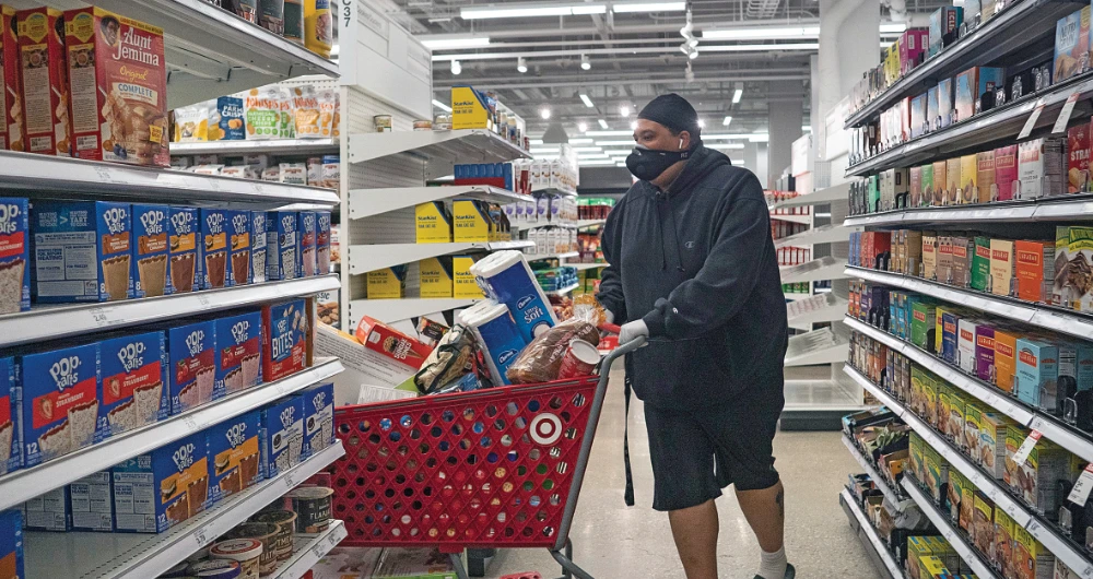 A man shops at Target in the Tenleytown area of Washington. Economic interventions and eye-popping sums are needed to protect Americans from the recent health and financial fallout. (AP)