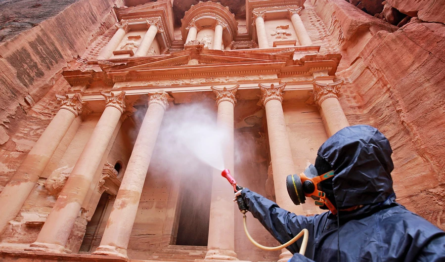 A laborer sprays disinfectant in Jordan’s archaeological city of Petra south of the capital Amman to prevent the spread of coronavirus on Tuesday. (AFP)