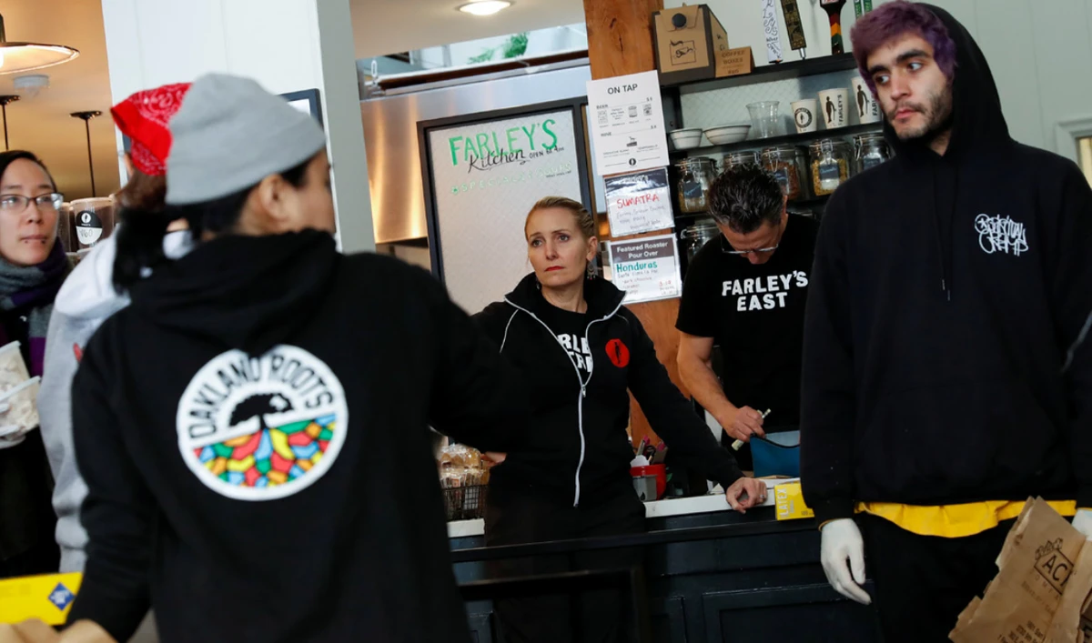 Laid off employees collect food products at the cafe in California. (Reuters)