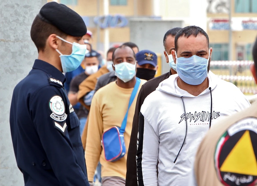 Expatriate workers returning from Egypt, Syria, and Lebanon arrive at a Kuwaiti health ministry containment and screening zone for COVID-19 coronavirus disease in Kuwait City on March 15, 2020. (File/AFP)