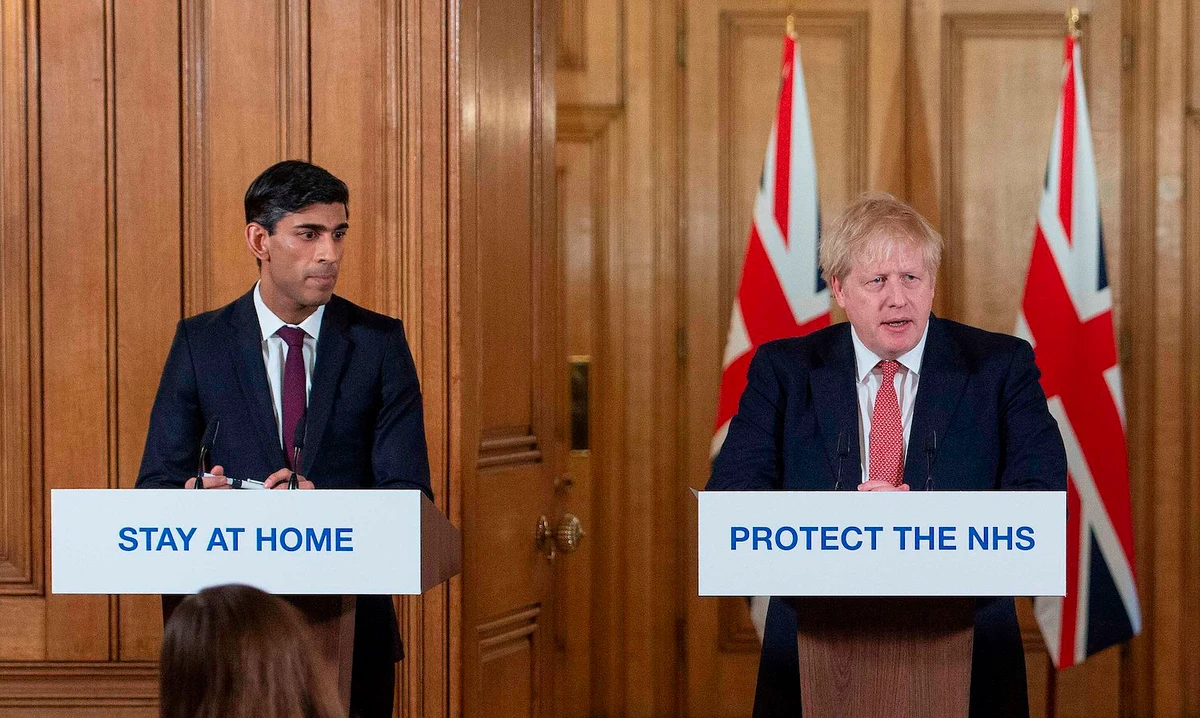 Britain's PM Boris Johnson (R) and Chancellor of the Exchequer Rishi Sunak attend a news conference to give a daily update on the government's response to the coronavirus outbreak, inside 10 Downing Street in London on March 20, 2020. (AFP)