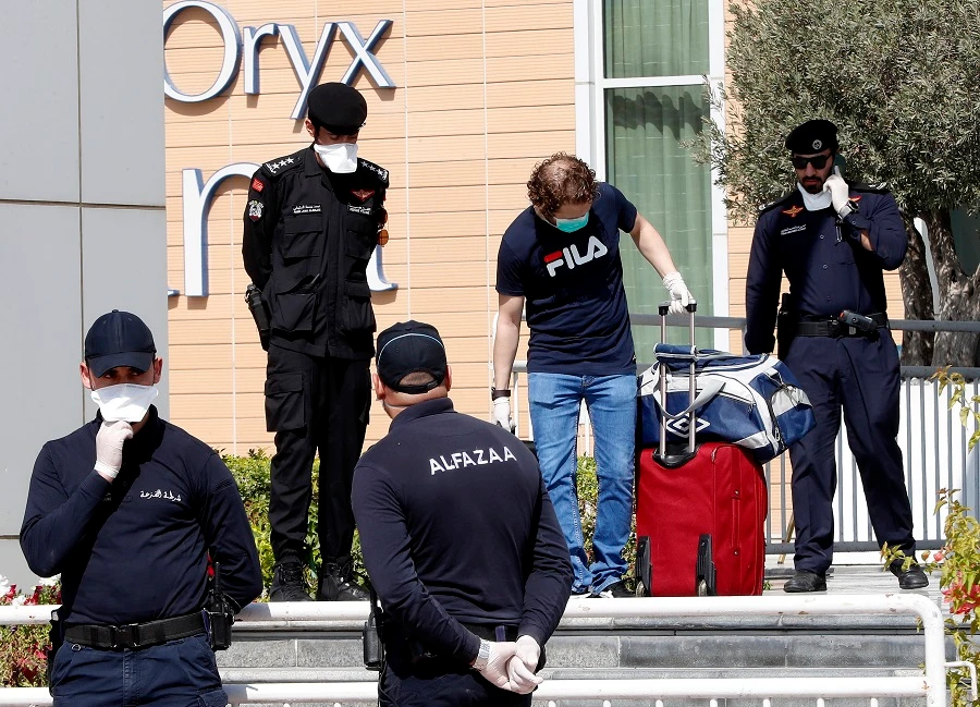 Qatari police stand outside a hotel in Doha where people have been quarantining over fears of coronavirus, on March 12, 2020. (File/AFP)