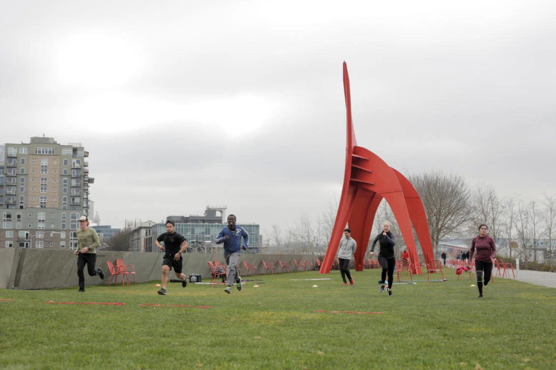 Members of the Axtion Club gym exercise at the Olympic Sculpture Park while maintaining a larger than usual distance from each other, during the coronavirus disease (COVID-19) outbreak, in Seattle, Washington, on March 21, 2020. (REUTERS/David Ryder)