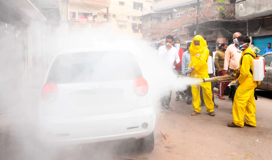Members of Welfare Society wearing protective gear spray disinfectant on a street amid concerns over the spread of the COVID-19 novel coronavirus, in Amritsar on March 21, 2020. (AFP)