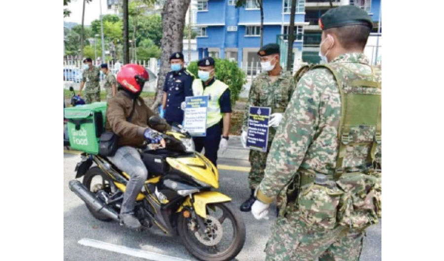 Food delivery motorbike drivers at a military checkpoint. Photo courtesy: (Ministry of Defense)