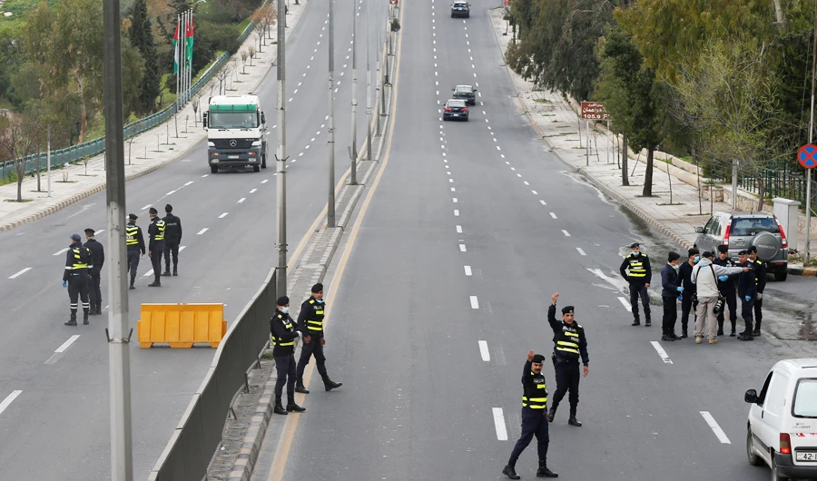 Jordanian police personnel guard at a checkpoint during the second day of a nationwide curfew, amid concerns over the coronavirus disease (COVID-19) spread, in Amman, Jordan March 22, 2020. (REUTERS)