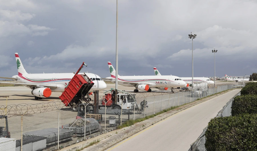 Lebanon's Middle East Airlines (MEA) planes are parked on the tarmac of Beirut International Airport amid restrictions to combat the coronavirus across the country on March 19, 2020. Lebanon urged people to stay at home for two weeks and closed the main airport to stem a novel coronavirus outbreak. (AFP)