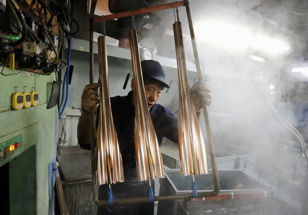 The torches for the 2020 Tokyo Olympics are manufactured at a factory in Tokyo in this photo taken on Jan, 31 and released by Kyodo on Monday. (Reuters)