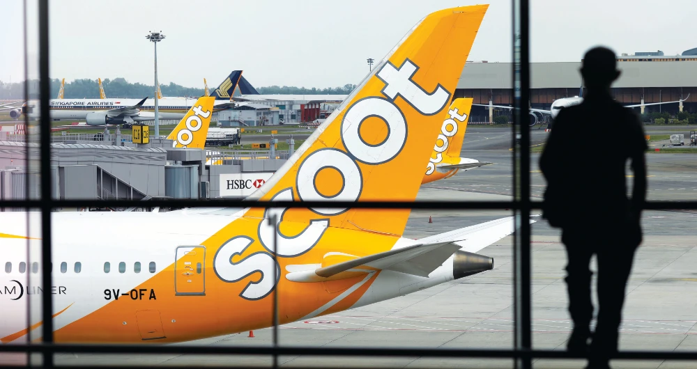 Scoot and Singapore Airlines aircraft sit on the tarmac at Changi Airport, following the outbreak of the coronavirus disease. (Reuters)