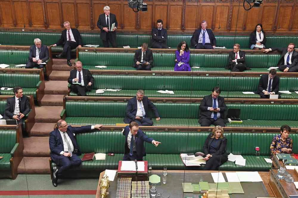 A handout photograph released by the UK Parliament shows Britain’s Health Secretary Matt Hancock standing at the dispatch box and speaking during the Coronavirus Bill debate to socially distanced MPs in the House of Commons in London on March 23, 2020. (Jessica Taylor/UK Parliament/AFP)