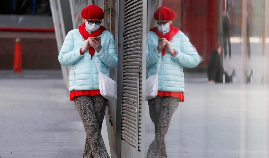 A woman at a closed shop near Piccadilliy Circus in central London on Tuesday. Britain has imposed its most draconian peacetime restrictions due to the spread of the coronavirus on businesses and social gatherings. (AP)