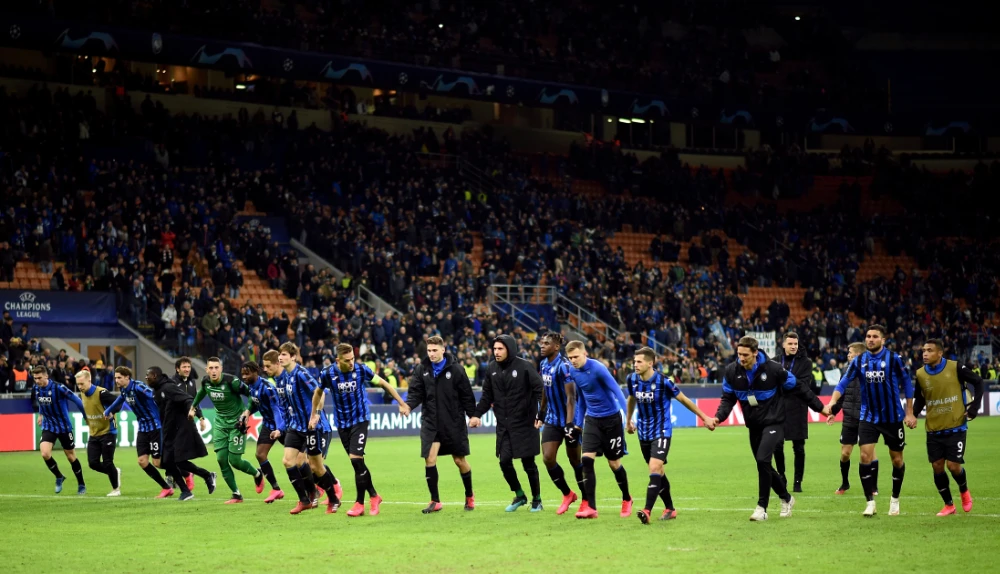 In this Feb. 19, 2020 photo, Atalanta players celebrate in front of their fans after the match with Valencia in Milan, Italy in the first leg of the UEFA Champions League round of 16. (REUTERS/Daniele Mascolo/File Photo)
