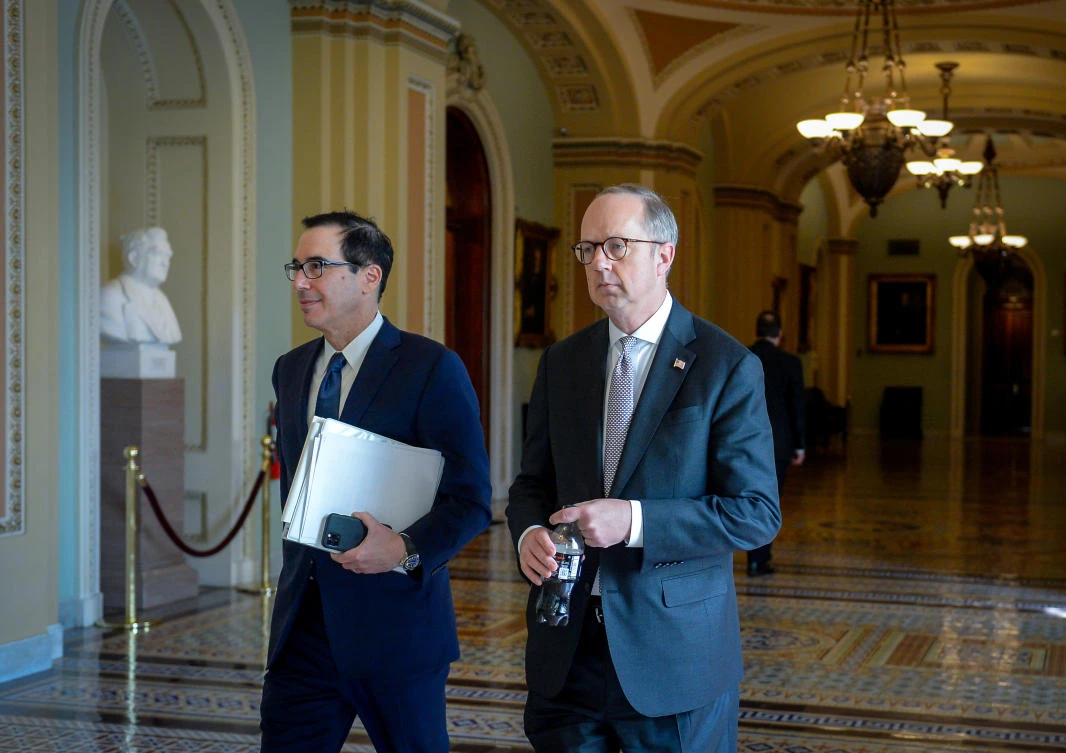 White House Director of Legislative Affairs Eric Ueland and Treasury Secretary Steve Mnuchin walk through the U.S. Capitol between meetings to wrap up work on coronavirus economic aid legislation, during the coronavirus disease (COVID-19) outbreak, in Washington, U.S., March 22, 2020. (Reuters)