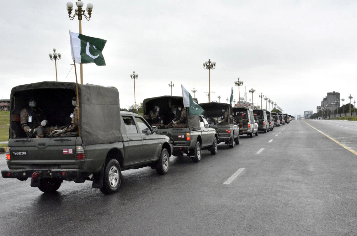 Pakistan’s national flags flutter on an army convoy patrolling during a partial lockdown after Pakistan shut all markets, public places and discouraged large gatherings amid an outbreak of coronavirus. (Reuters)