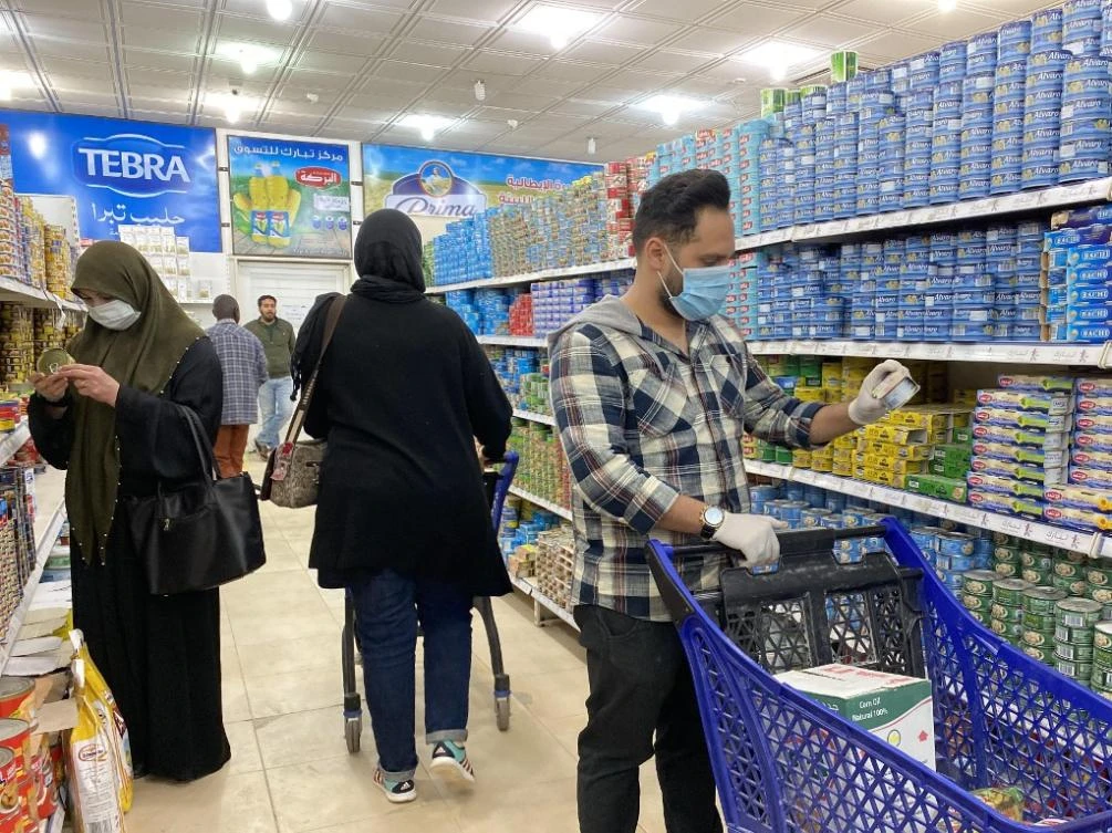 Libyans, wearing protective face masks, shop at a supermarket in the capital Tripoli on March 15, 2020. The war-torn country has reported its first case of the novel coronavirus. (AFP file photo)