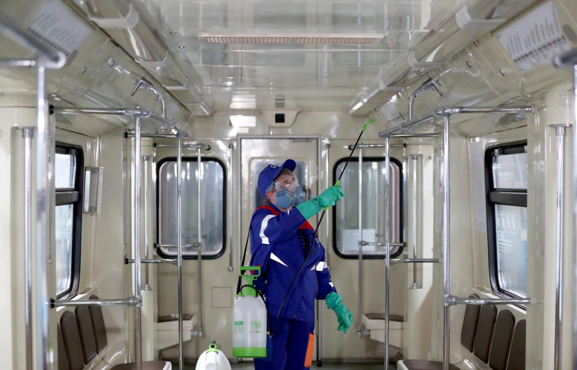 A worker sprays disinfectant in a metro train due to the outbreak of the coronavirus disease in Moscow, Russia on March 25, 2020. (Reuters)