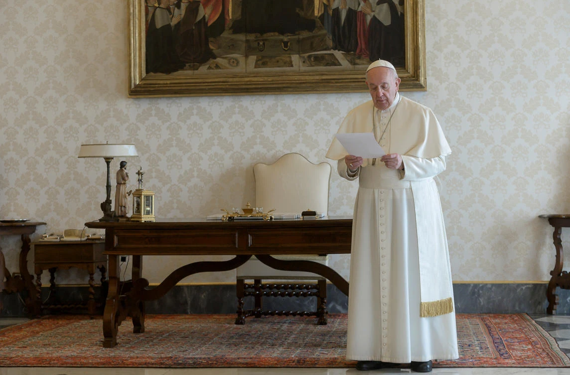 Pope Francis speaks ahead of reciting the "Our Father" from a library inside the Vatican as a response to the coronavirus disease (COVID-19) outbreak, after calling for Christians all over the world to recite the prayer together at noon, at the Vatican, March 25, 2020. (Reuters)