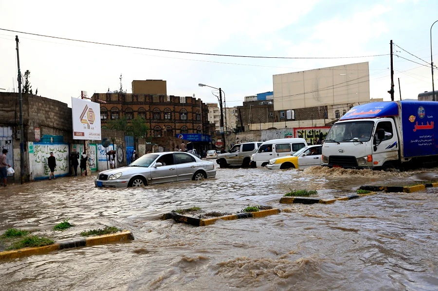 Cars drive through a flooded road following heavy rainfall in the Yemeni capital Sanaa on May 26, 2019. (File/AFP)