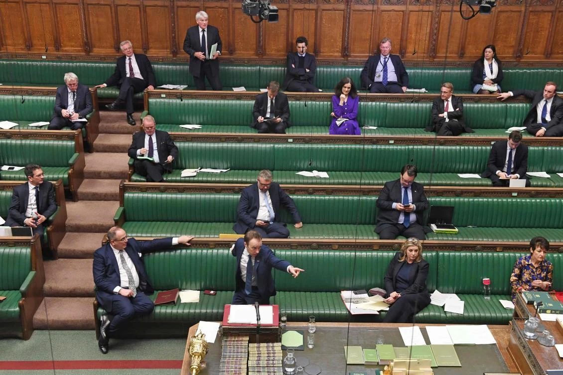 Britain’s Health Secretary Matt Hancock stands at the dispatch box and speaks during the Coronavirus Bill debate to socially distanced MPs in the House of Commons in London on March 23, 2020. (AFP)