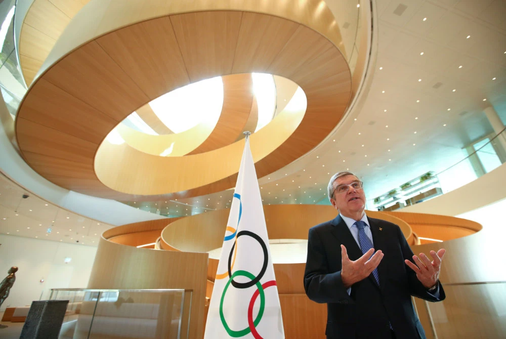 International Olympic Committee (IOC) President Thomas Bach gestures as he is interviewed in Lausanne, Switzerland, after the historic decision to postpone the 2020 Tokyo Olympic Games due to the coronavirus pandemic on March 25, 2020. (AFP)