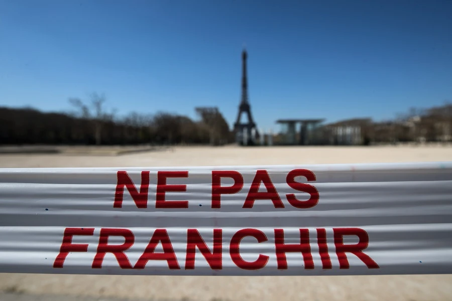 A photo shows the empty Champs-de-Mars with the Eiffel Tower and a cordon reading “Do not cross” in Paris, on March 25, 2020, on the ninth day of a lockdown aimed at curbing the spread of the COVID-19 in France. (Joel Saget/AFP)