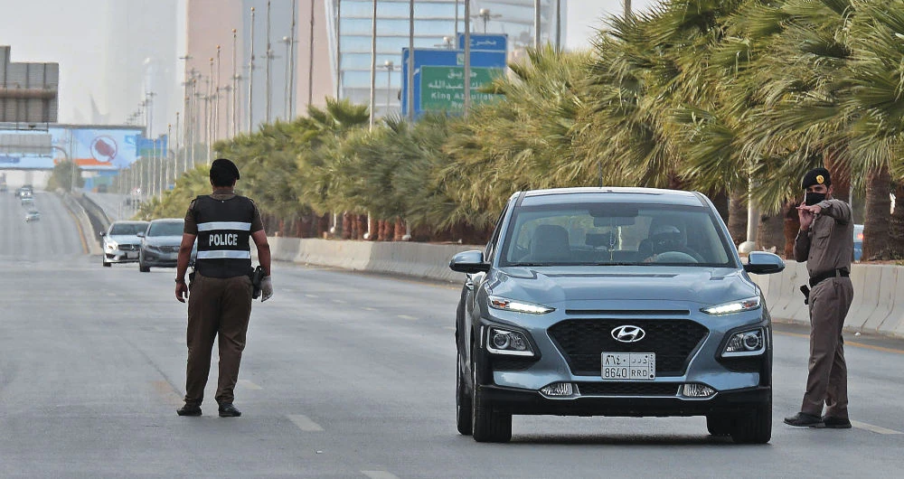 Policemen manning a checkpoint in Riyadh on the day of an emergency G20 videoconference to discuss a response to the coronavirus crisis. (AFP)