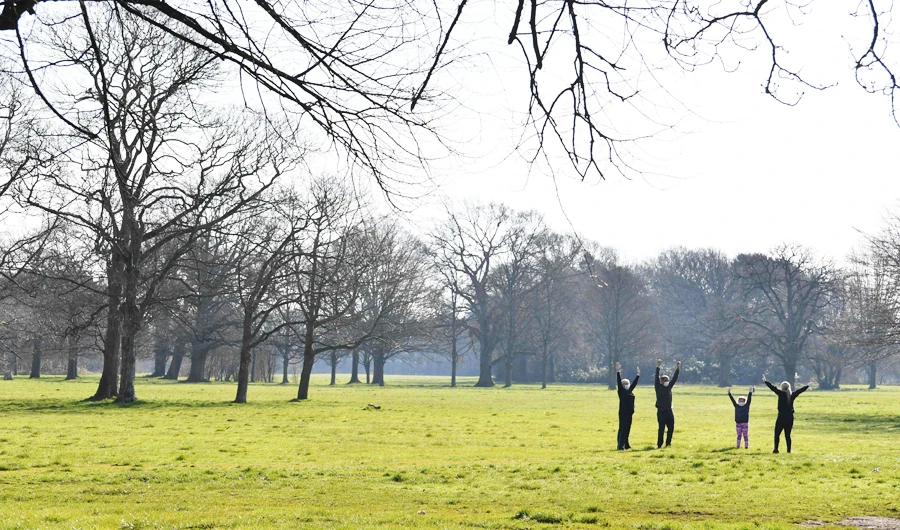 A family exercise in Wythenshawe Park in Manchester, northwest England, on March 25, 2020, after Britain's government ordered a lockdown to slow the spread of the novel coronavirus. (AFP)