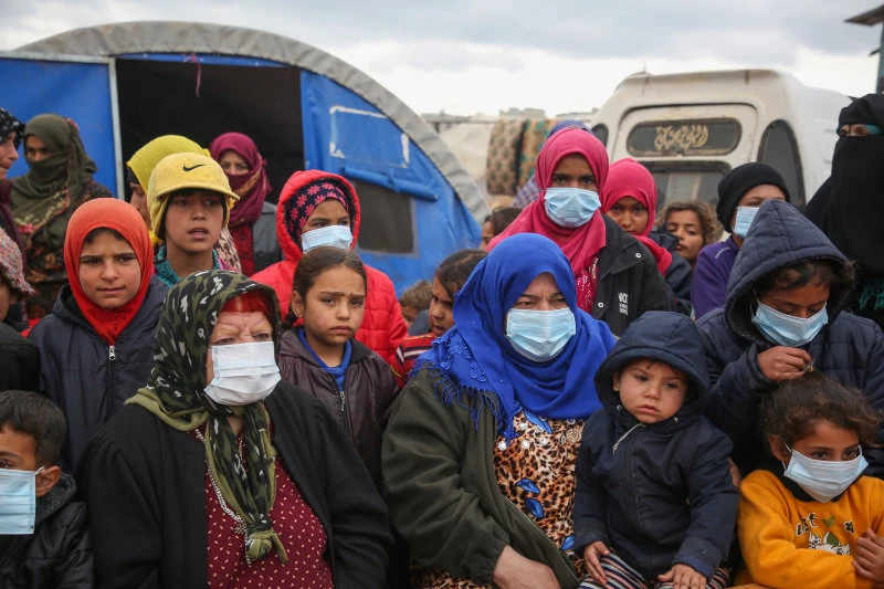 Displaced Syrian attend a COVID-19 awareness campaign in a camp for displaced people in Kafr Lusin, Idlib, on March 18, 2020. (Photo by Mohammed Al-Rifai / AFP)