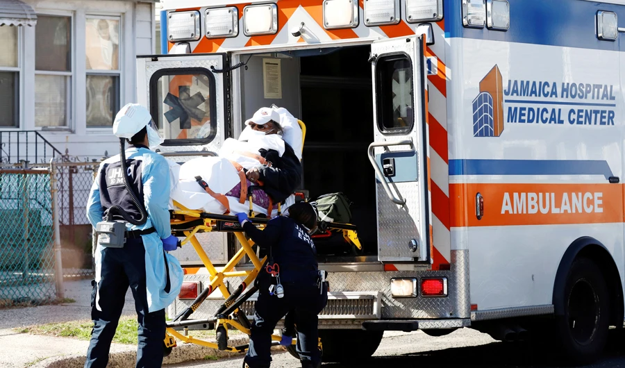 Emergency Medical Technicians (EMT) lift a patient into an ambulance while wearing protective gear, as the outbreak of coronavirus disease (COVID-19) continues, in New York City, New York, U.S., March 24, 2020. (REUTERS)
