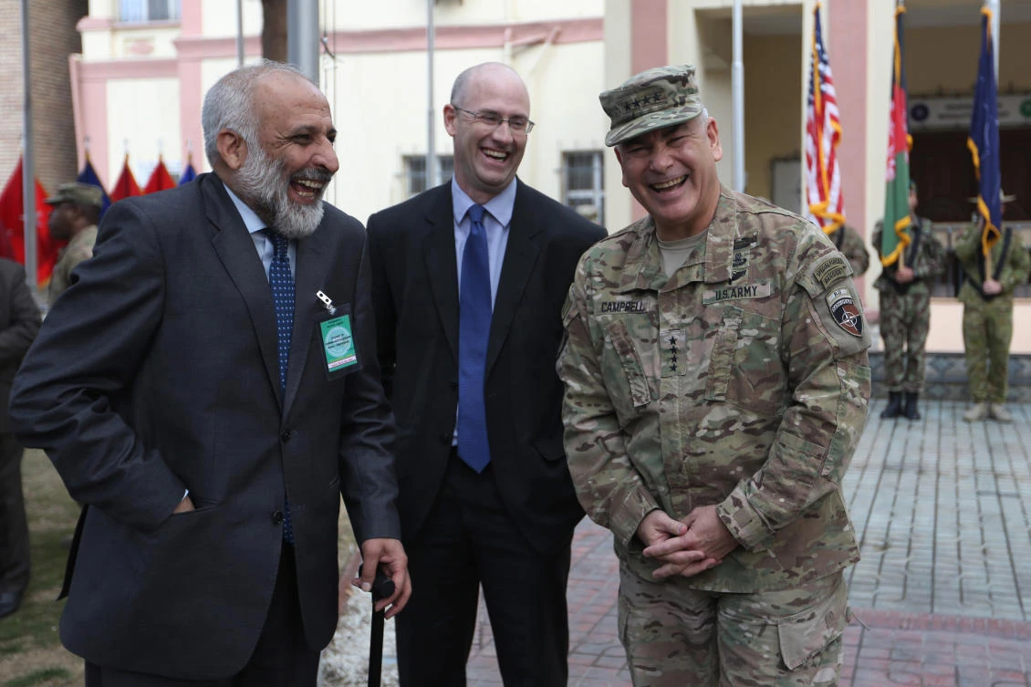 In this March 2, 2016, file photo, outgoing Commander of Resolute Support forces and United States forces in Afghanistan, U.S. Army General John Campbell, right, and Afghan head of Afghan government peace negotiating team Mohammad Masoom Stanikzai, left, laugh during a change of command ceremony in Resolute Support headquarters in Kabul, Afghanistan. (AP)