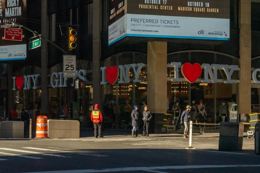 A tour bus ticket vendor stands on a normally busy 7th Avenue on March 12, 2020 in New York City. Many New Yorkers are heeding the advice of officials after the state banned large gatherings of 500 people or more and recommended practicing "social distancing" during the COVID-19 pandemic. (AFP)