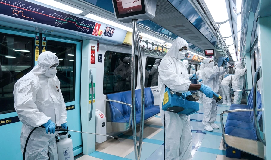 Members of a medical team wearing protective suits spray disinfectants on the metro, after a curfew was imposed to prevent the spread of the coronavirus disease (COVID-19), in Dubai, United Arab Emirates, March 27, 2020. (REUTERS)