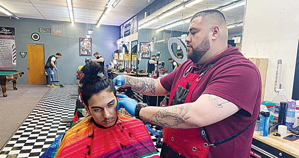 Jesus Ruiz cuts hair at Ivan Barber Studio, which has stayed open in Guymon, Oklahoma, a city where there has yet to be a positive case of coronavirus. (Reuters)