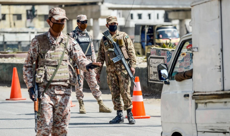 Security personnel wearing facemasks stand guard at a checkpoint during a government-imposed nationwide lockdown as a preventive measure against the COVID-19 coronavirus, in Karachi on March 28, 2020. (AFP)