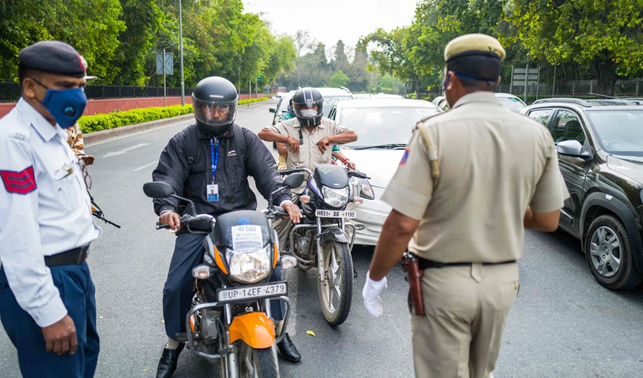 Police check motorists at a checkpoint during a government-imposed nationwide lockdown as a preventive measure against the COVID-19 coronavirus in New Delhi on March 26, 2020. (AFP)