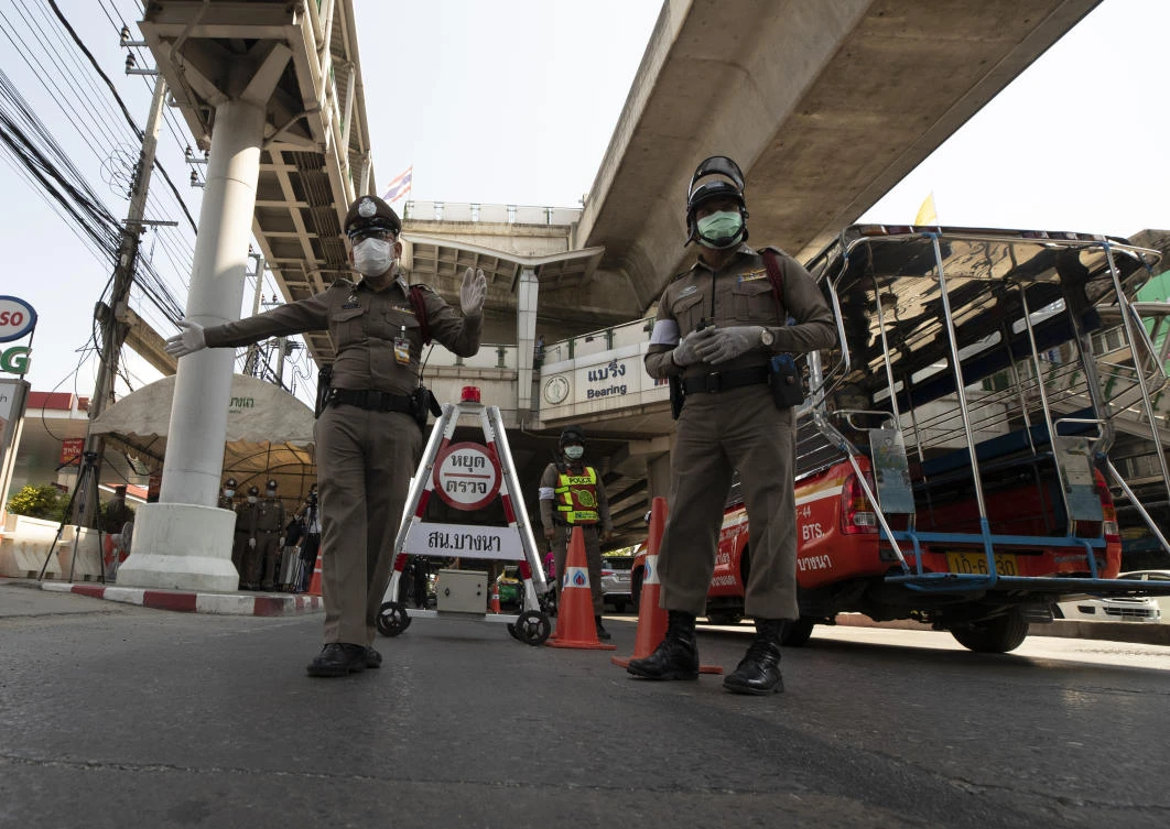 Policemen wear face masks to protect themselves from new coronavirus at a health check point in Bangkok, Thailand, Thursday, March 26, 2020. (AP)