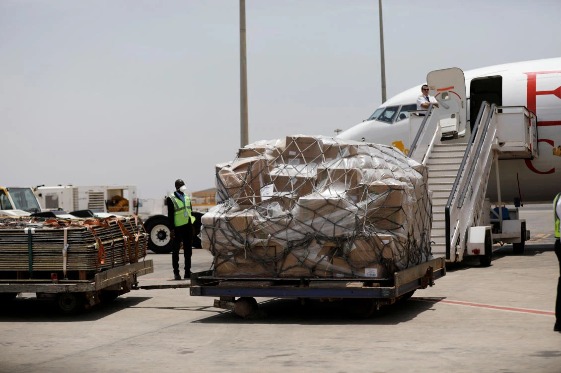 An airport worker looks at a shipment of medical supplies donated to help Africa for fight with the coronavirus disease (COVID-19) from Chinese billionaire Jack Ma and the Alibaba Foundation, after it arrived from Ethiopia at Blaise Diagne international airport in Thies, Senegal March 28, 2020. (Reuters)