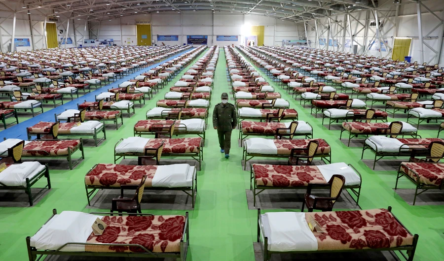 An Iranian army soldier walks through a temporary hospital in Tehran, Iran, Thursday, March 26, 2020. (AP)