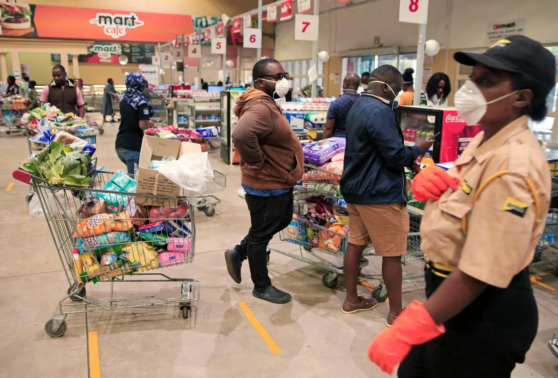 People queue to pay for goods at a supermarket ahead of a nationwide 21-day lockdown. (Reuters)