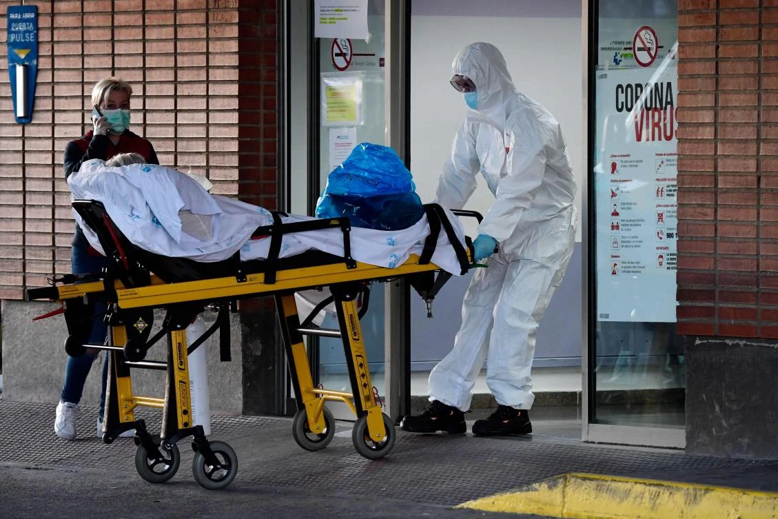 A Spanish health worker transfers a patient on a stretcher at the Severo Ochoa hospital in Leganes, Madrid. Spain currently has the world’s second highest death toll after Italy. (AFP)
