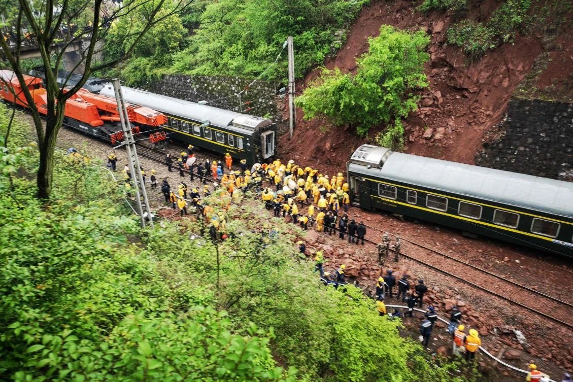 Rescuers search at the site where a train derailed in Chenzhou in China’s central Hunan province. (AFP)