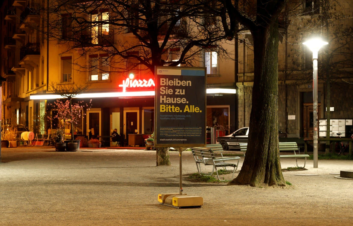 A sign reading “Stay at home. Please. All.” is put up as part of protection measures against the coronavirus on Idaplatz square in Zurich, Switzerland on March 28, 2020. (Reuters)