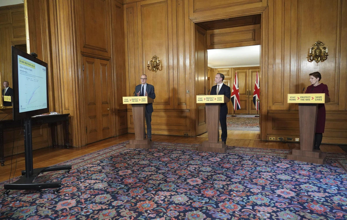 Britain’s Chief Scientific Adviser Sir Patrick Vallance, left, Foreign Secretary Dominic Raab and Public Health England medical director Yvonne Doyle answer questions from the media via a video link. (AP Photo)