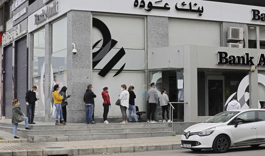 Lebanese queue outside a bank in the Zalka suburb of Beirut on Sunday. (AFP)