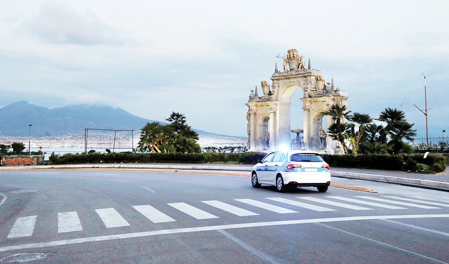 A police car passes the Maschio Angioino castle, as Italy struggles to contain the spread of coronavirus disease (COVID-19), in Naples on Sunday. (Reuters)