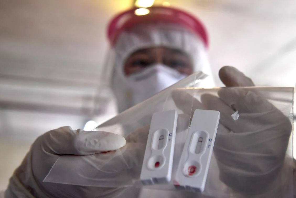 A Thai medical staff member shows a new rapid testing kit to combat the spread of coronavirus at Chulalongkorn University in Bangkok on March 30, 2020. (AFP)