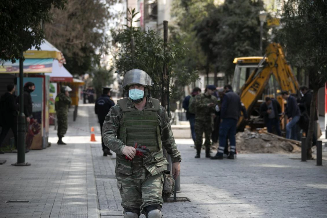 A military officer walks attends an operation at Ermou Street, Athens' main shopping area on Tuesday, March 31, 2020. Police in Greece have cordoned off an area near the country's parliament after workers found what is believed to be a decades-old mortar shell during maintenance on the water mains. (AP/Yorgos Karahalis)