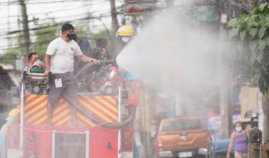 A fireman sprays disinfectant from the back of a firetruck to help curb the spread of the COVID-19 during a localized quarantine in Manila. (AP)